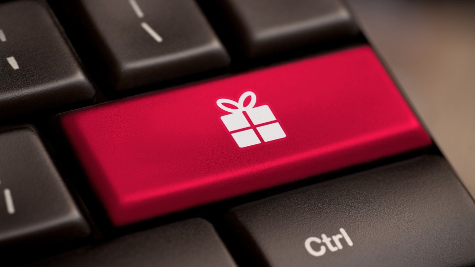 Close-up of a computer keyboard with a bright red key featuring a white gift box icon, located next to the black Ctrl key.