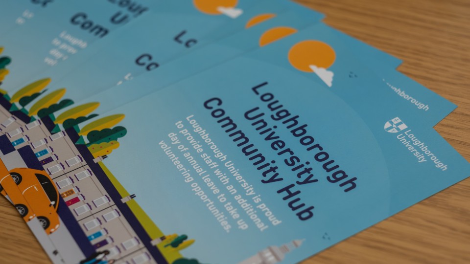 Leaflets spread across a table with the title 'Loughborough University Community Hub'