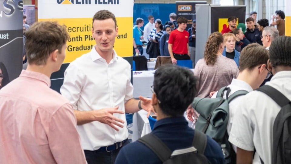 Employer chatting with students at a career fair