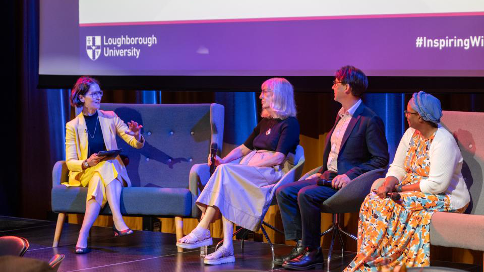 UNESCO UK representatives sat on chairs on a stage speaking with Professor Chmutina